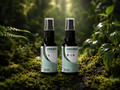 Immune Defence Kit spray bottles labeled 'IMMUNITY MEDICINE' and 'CANCERBUSH MEDICINE' standing on mossy ground with green plants and a blurred forest background. Terupharma