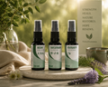 Three Terupharma medicine spray bottles displayed on a stone tray with natural elements in a warm, sunlit setting. The bottles are labeled Reishi Medicine, Cancerbush Medicine, and Immunity Medicine.